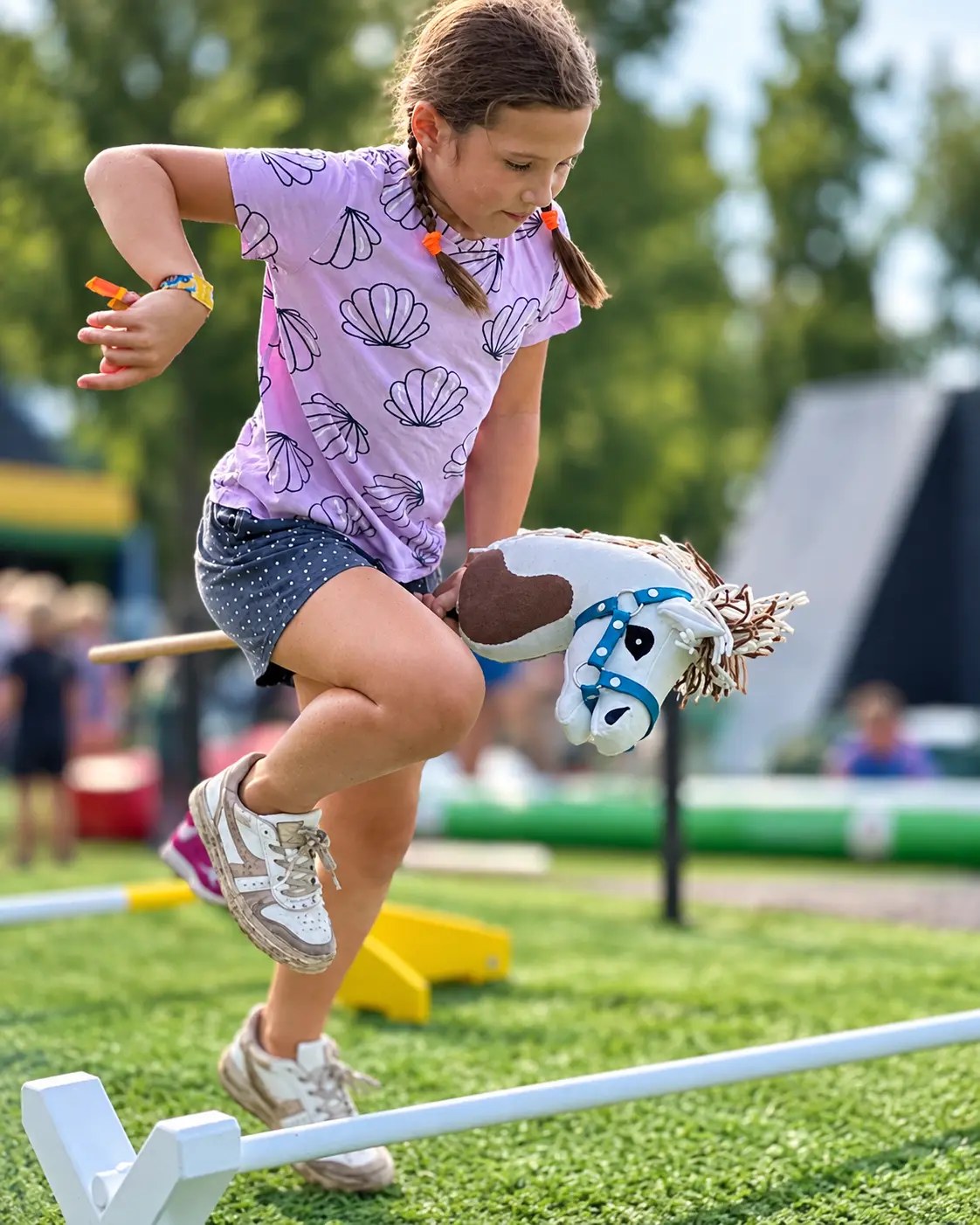 A child jumping with a hobby horse