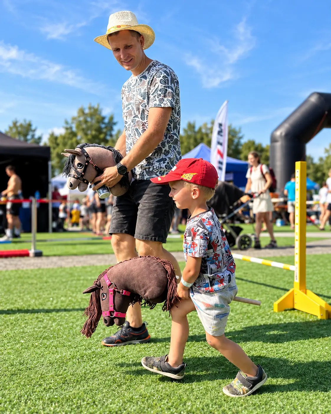 An adult and a child playing together with hobby horses
