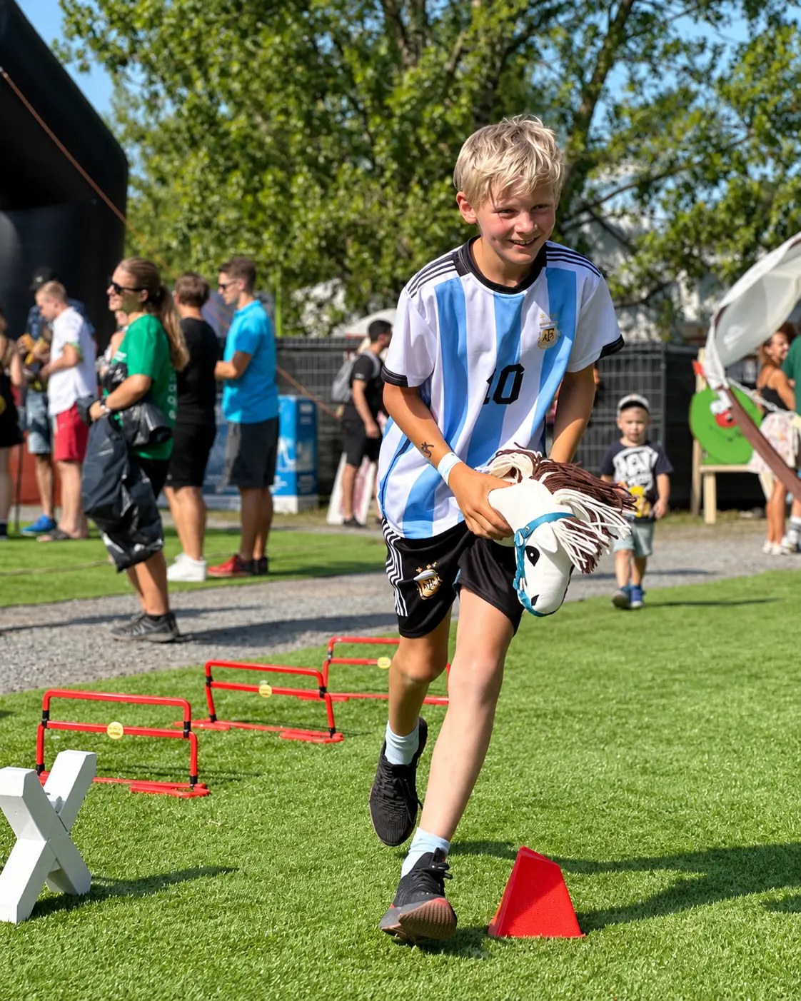 An older child running with a hobby horse
